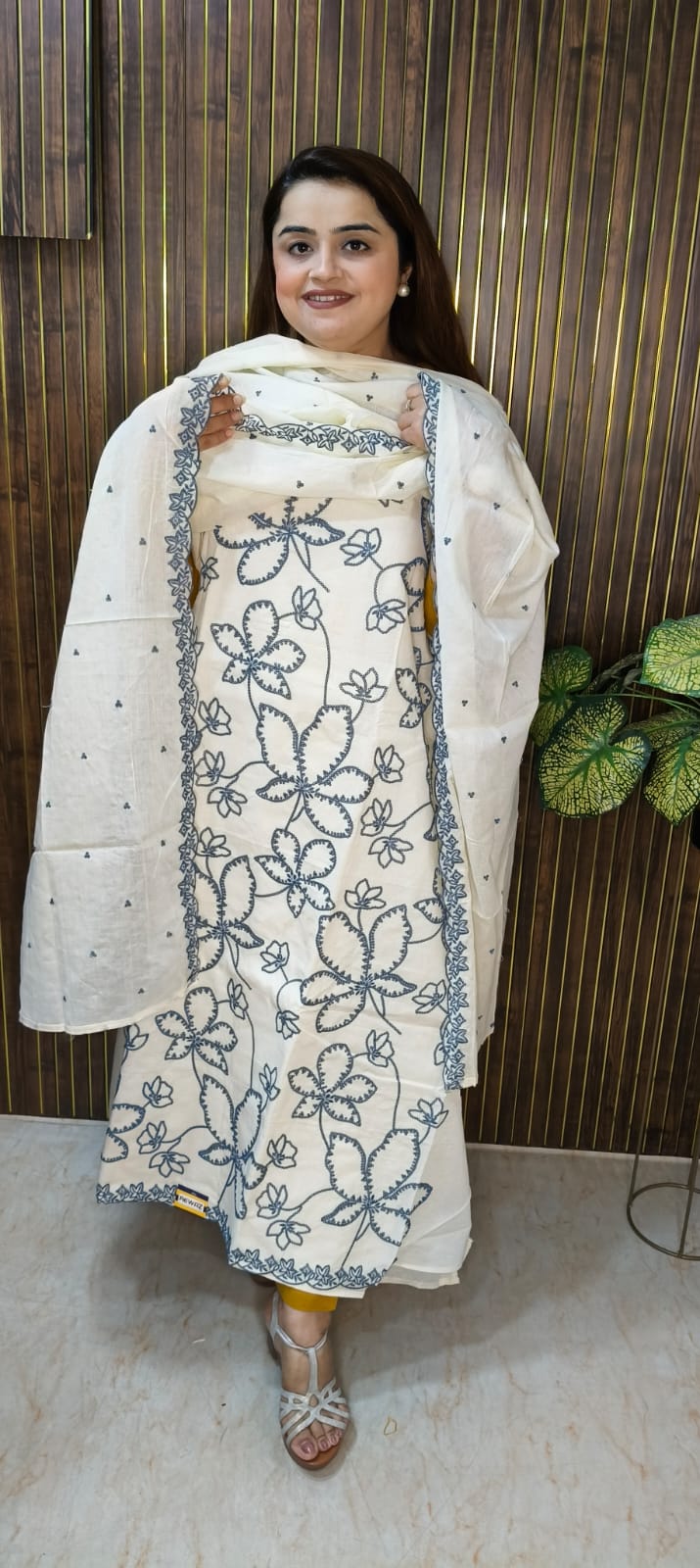 "Elegant White Cotton Suit with Vibrant Threadwork."