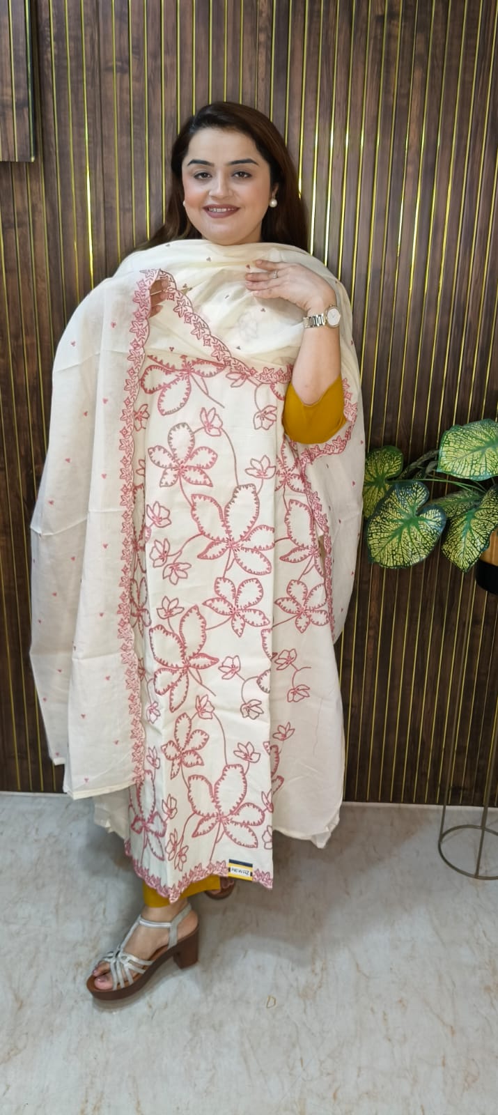 "Elegant White Cotton Suit with Vibrant Threadwork."